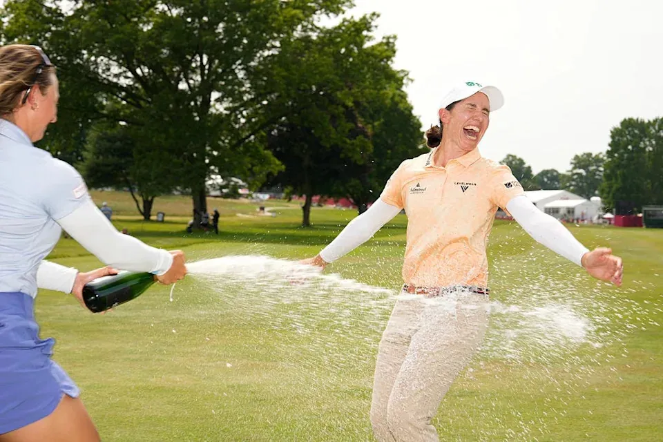 Carlota Ciganda of Spain is sprayed with champagne by Emily Kristine Pedersen of Denmark after winning the Meijer LPGA Classic for Simply Give 2025 at Blythefield Country Club on June 15, 2025 in Grand Rapids, Michigan.