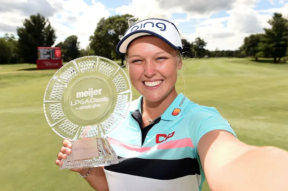 Brooke Henderson of Canada imitates a selfie as she poses with the championship trophy during the final round of the Meijer LPGA Classic at Blythefield Country Club on June 18, 2017 in Grand Rapids, Michigan.