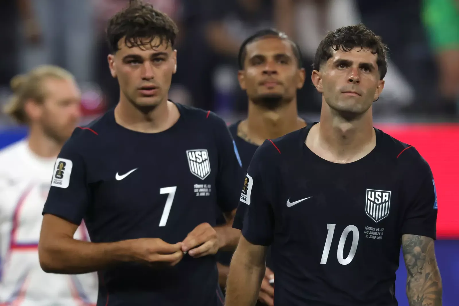 U.S. players Gio Reyna, left, and Christian Pulisic walk onto the field after a 3-2 loss to Turkey at the World Cup.