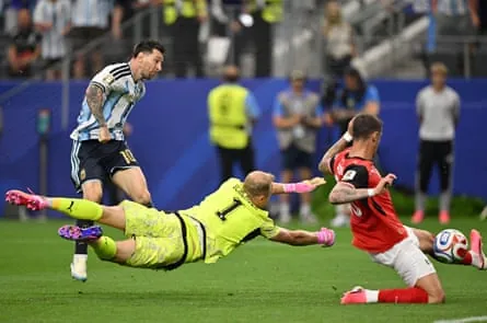 Lionel Messi scores past a diving Alexander Schlager and an Austria defender