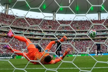 Uruguay’s Fernando Muslera fumbles Álex Baena’s shot over the line.