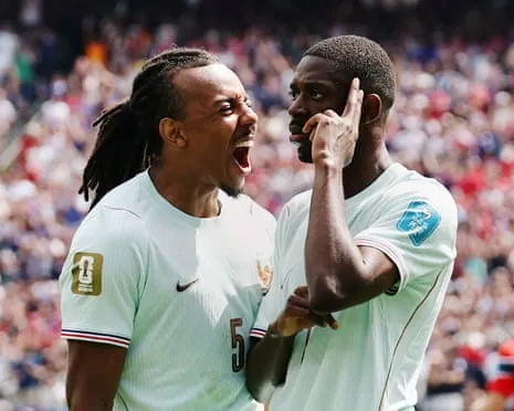 Ousmane Dembélé points his fingers up and Jules Koundé celebrates
