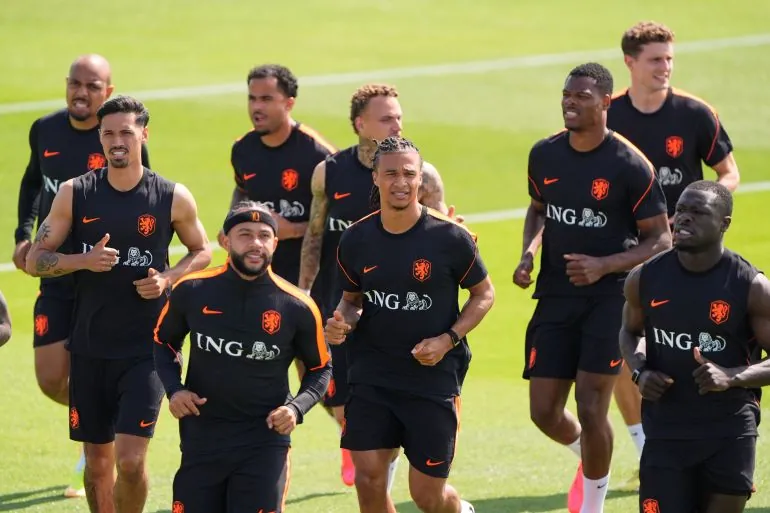 Netherlands team members practice on the pitch.