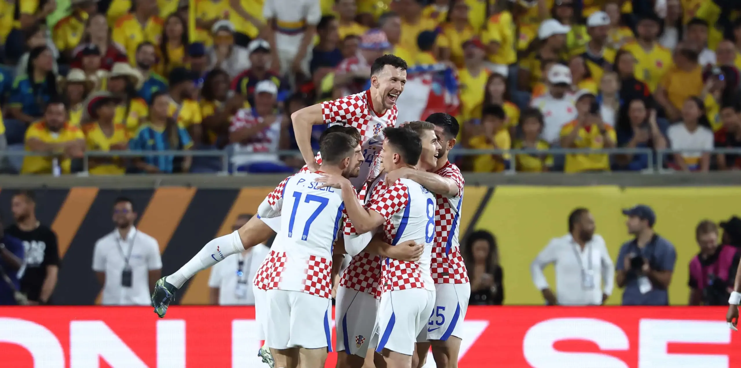 Ivan Perisic jumps on his Croatia teammates in celebration.