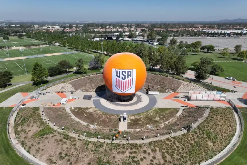 An aerial view of a U.S. Soccer banner hanging on the exterior of a Great Park balloon ride.
