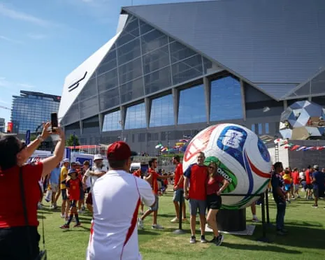 Fans pose for photos outside the stadium before the World Cup match between Spain and Cape Verde