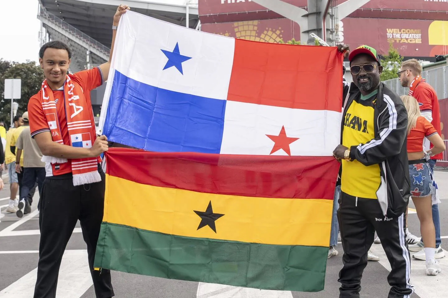 Fans of Panama and Ghana holding up flags of both countries