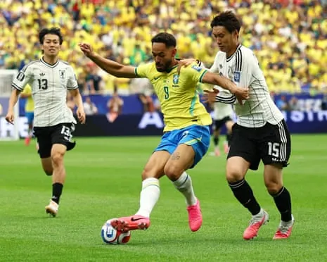 Brazil's Matheus Cunha in action with Japan's Daichi Kamada.