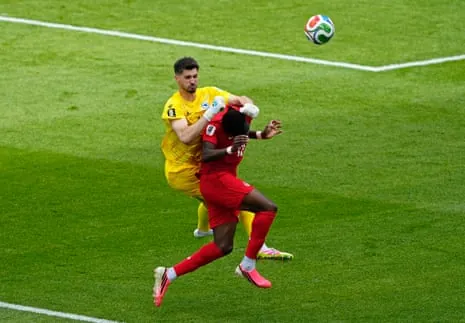 Bosnia and Herzegovina's Nikola Vasilj collides with Canada's Tani Oluwaseyl.