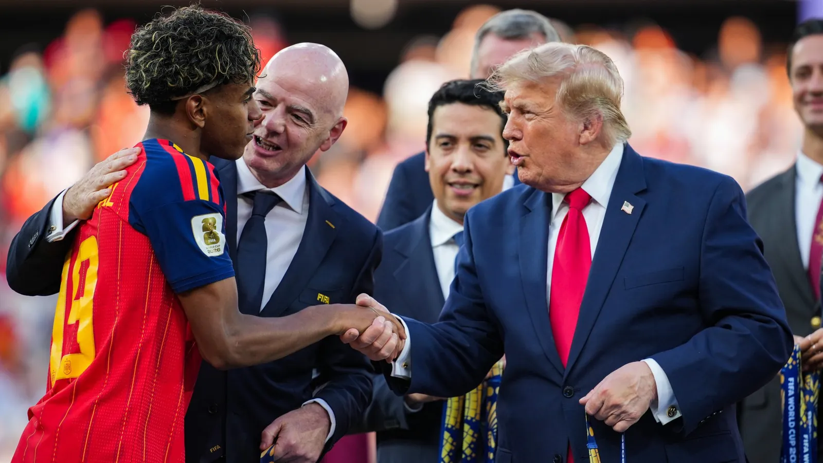 U.S. President Donald Trump (right) and FIFA president Gianni Infantino (second from left) congratulate Lamine Yamal of Spain as they present him with the winners medal on Sunday.