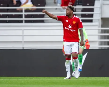 Andrey Santos in a red Manchester United kit points while walking on the pitch during a pre-season friendly against Wrexham in Helsinki