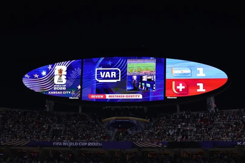 KANSAS CITY, MISSOURI - JULY 11: A graphic on the LED screen showing the VAR decision to overturn a yellow card for mistaken identity during the FIFA World Cup 2026 Quarter Final match between Argentina and Switzerland at Kansas City Stadium on July 11, 2026 in Kansas City, United States. (Photo by Robbie Jay Barratt - AMA/Getty Images)