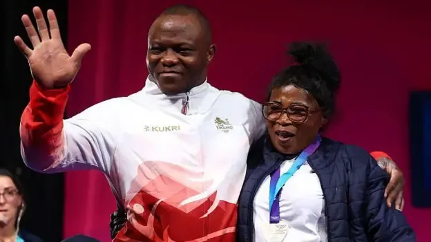 Silver medalist Cyrille Tchatchet II of Team England poses for a photo with family members