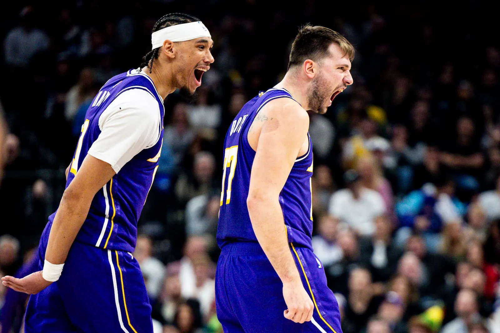 Los Angeles Lakers guard Luka Doncic (77) celebrates beside center Jaxson Hayes (11) after Doncic sunk a three-pointer against the Utah Jazz during an NBA game held at the Delta Center in Salt Lake City on Thursday, Dec. 18, 2025.Isaac Hale, Deseret News