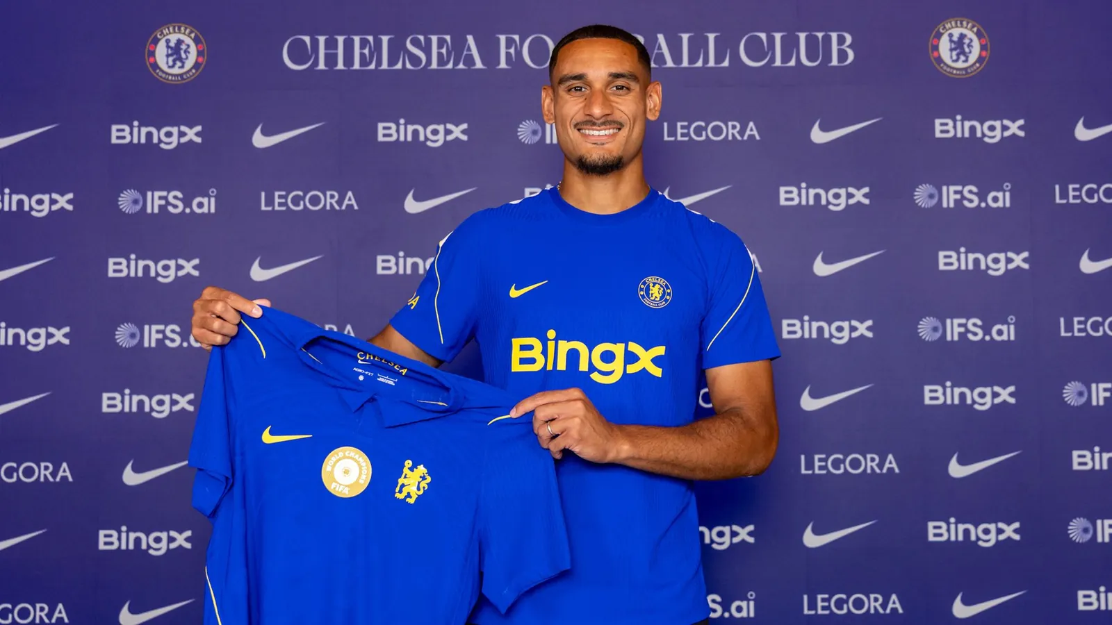 Lacroix is all smiles as he displays his new team's shirt