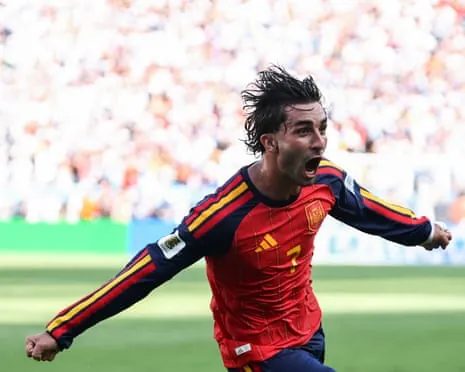 Ferran Torres shouts joyfully with arms outstretched while celebrating his World Cup final goal