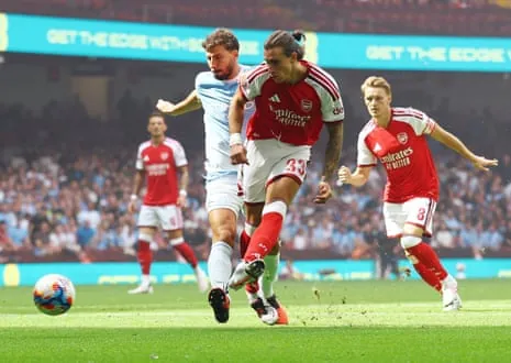 Arsenal's Riccardo Calafiori scores their first goal.