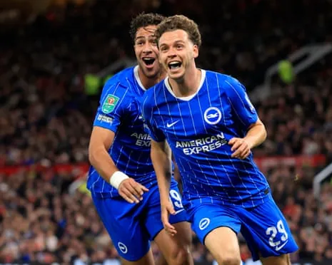 The Brighton players Charalampos Kostoulas and Maxim De Cuyper celebrate the latter scoring his team's third goal in their 3-2 win away to Manchester United in the third round of the Carabao Cup.